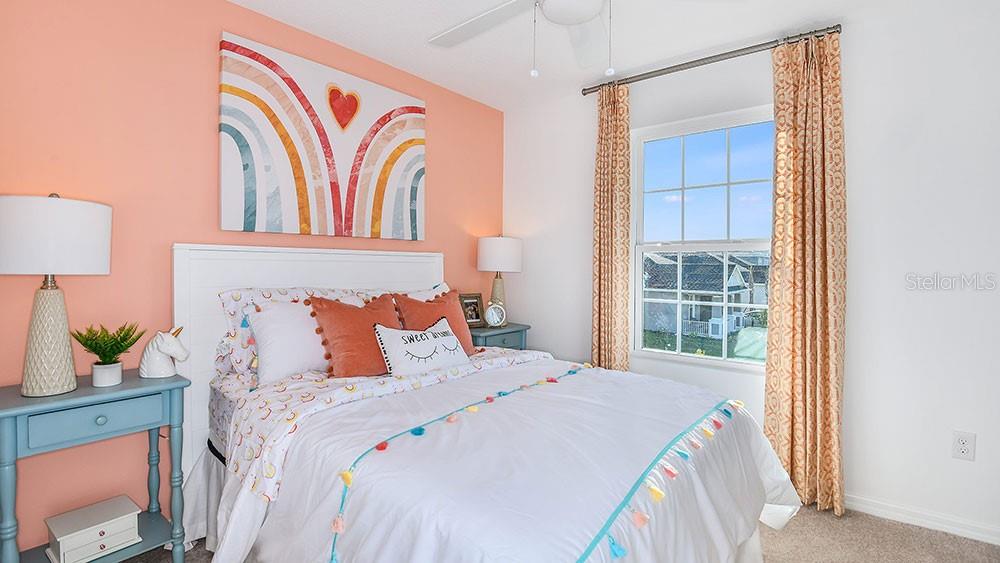 13811 Shellmore Avenue Palmetto, FL 34221 - Photo 6 of 17 a bed sitting in a bedroom next to a window