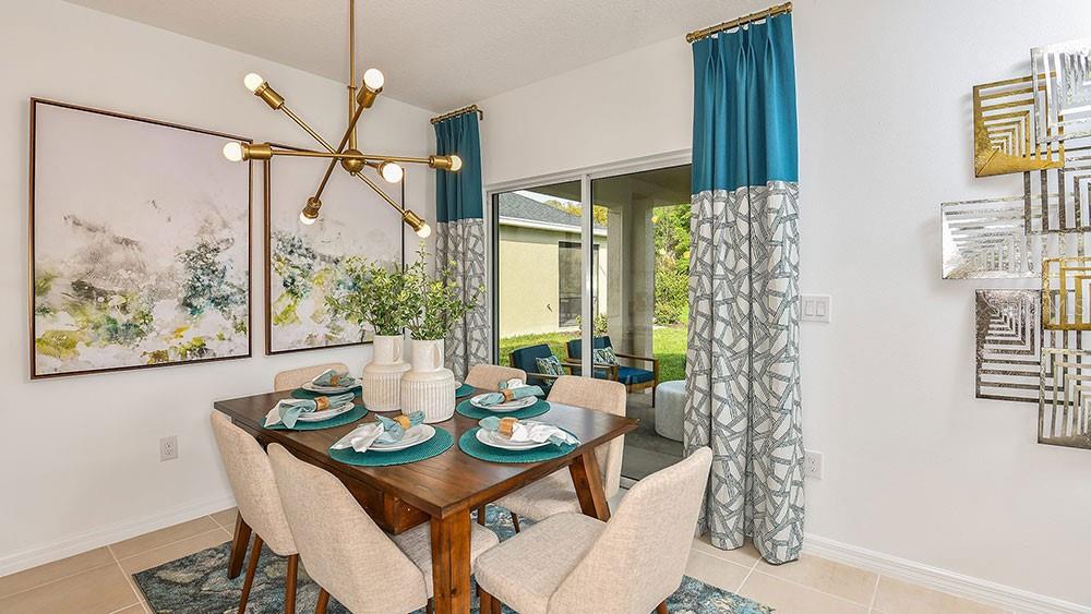 13811 Shellmore Avenue Palmetto, FL 34221 - Photo 9 of 17 a view of a dining room with furniture window and wooden floor