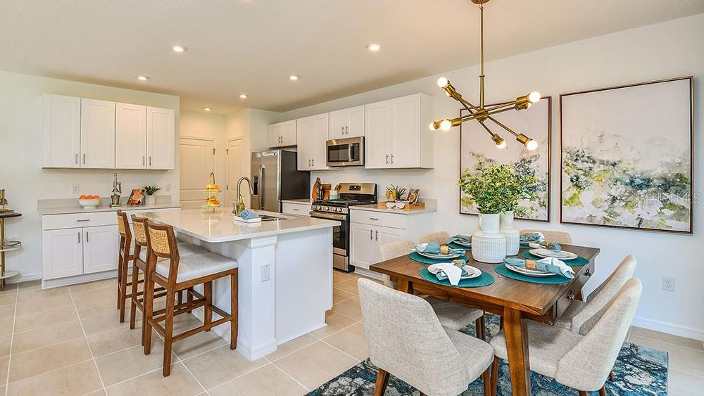 13811 Shellmore Avenue Palmetto, FL 34221 - Photo 10 of 17 a kitchen with a table chairs sink and cabinets