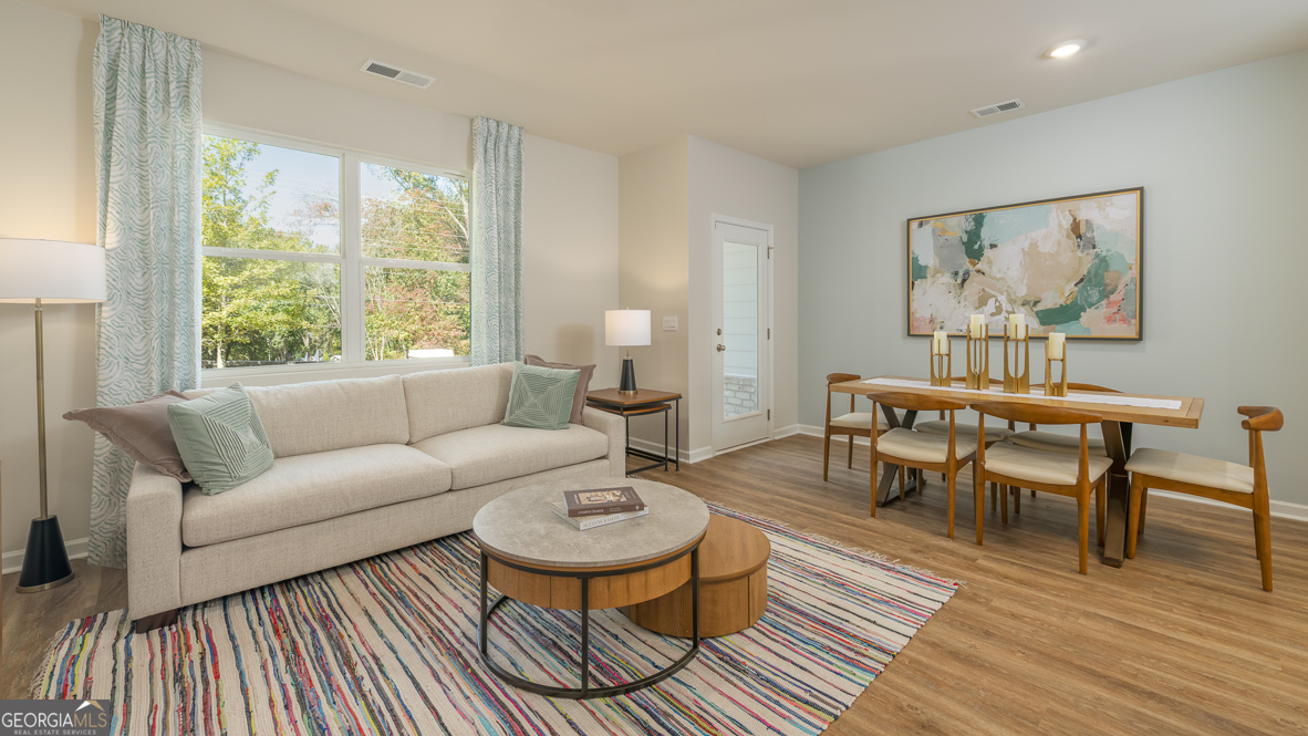 2082 Moss Hill Road Stone Mountain, GA 30088 - Photo 13 of 38 a living room with furniture and a wooden floor