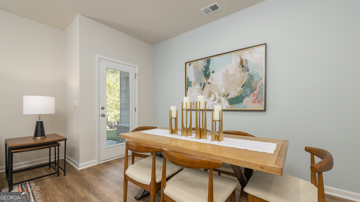 2082 Moss Hill Road Stone Mountain, GA 30088 - Photo 14 of 38 a view of a dining room with furniture and wooden floor