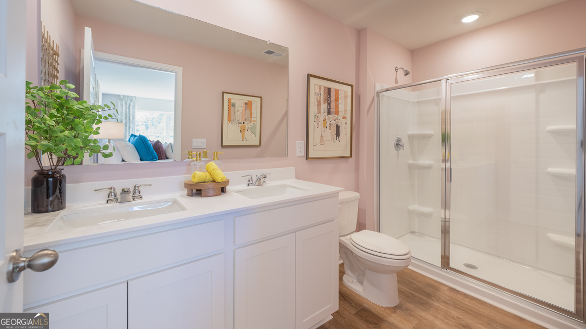 2082 Moss Hill Road Stone Mountain, GA 30088 - Photo 24 of 38 a bathroom with a double vanity sink toilet and shower