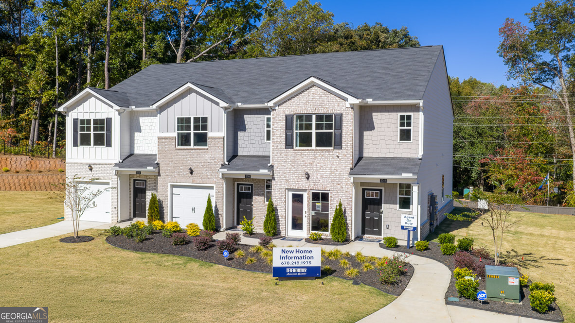 2082 Moss Hill Road Stone Mountain, GA 30088 - Photo 3 of 38 a view of a white house with large windows and couches chairs