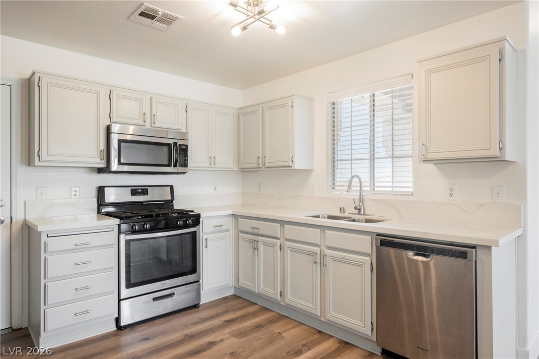 112 Iridescent Street Henderson, NV 89012 - Photo 9 of 24 A well-appointed kitchen showcasing contemporary cabinetry, durable countertops, and sleek stainless steel appliances.