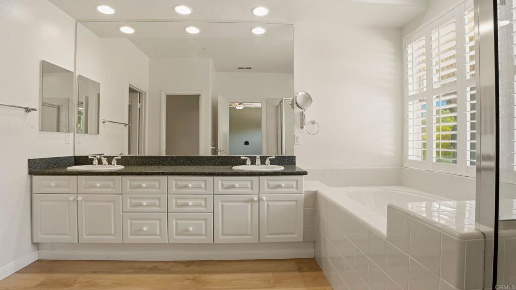 2527 Southern Oak Road Ramona, CA 92065 - Photo 27 of 56 a spacious bathroom with a granite countertop sink a mirror a bathtub and next to a window