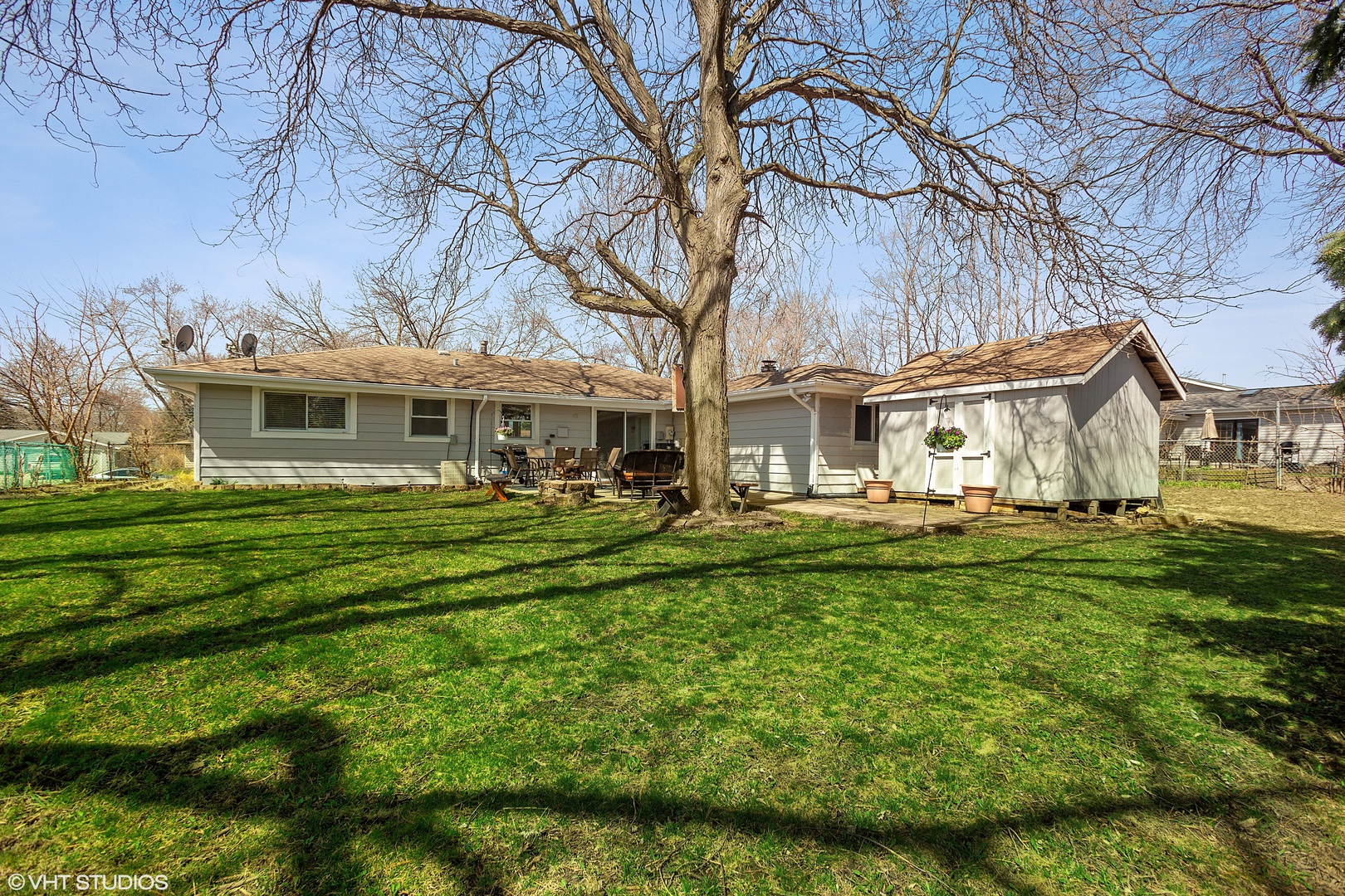 323 Springinsguth Road Schaumburg, IL 60193 - Photo 12 of 14 a front view of a house with a yard table and chairs