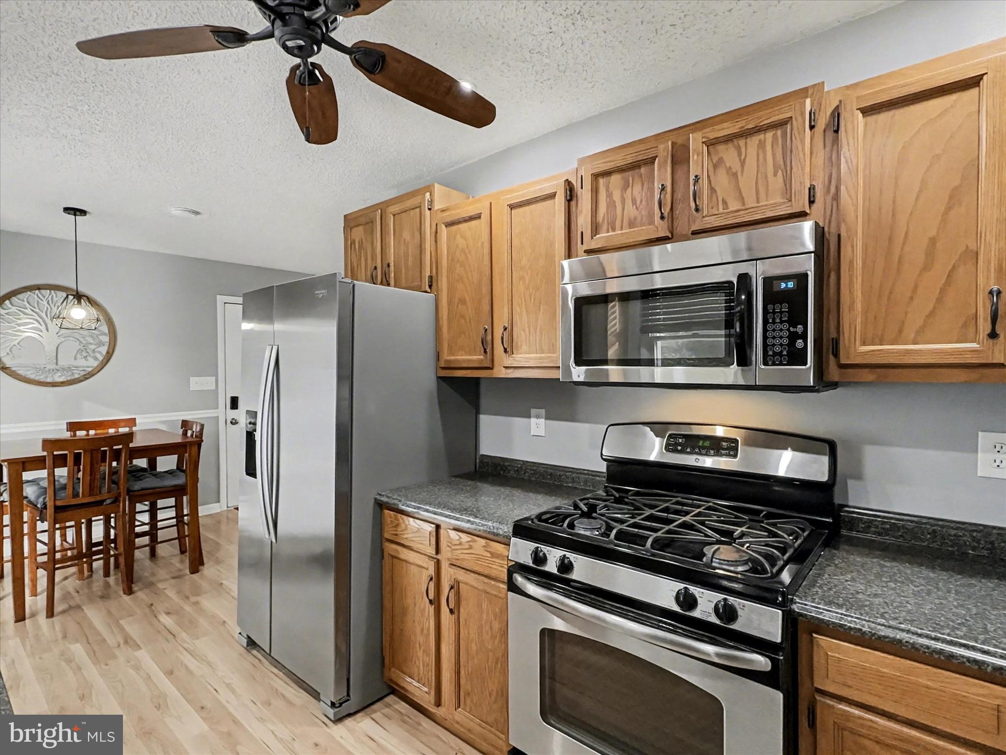 123 Overview Circle East Red Lion, PA 17356 - Photo 7 of 23 a kitchen with stainless steel appliances granite countertop a stove and a microwave