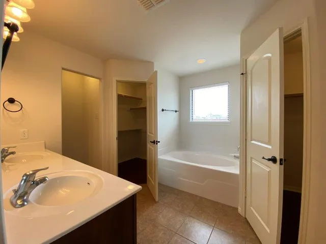 a bathroom with a sink a shower and a mirror