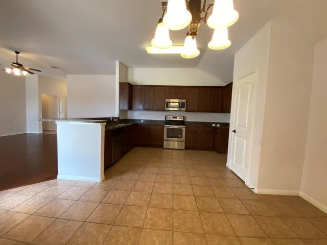 a large kitchen with cabinets and stainless steel appliances