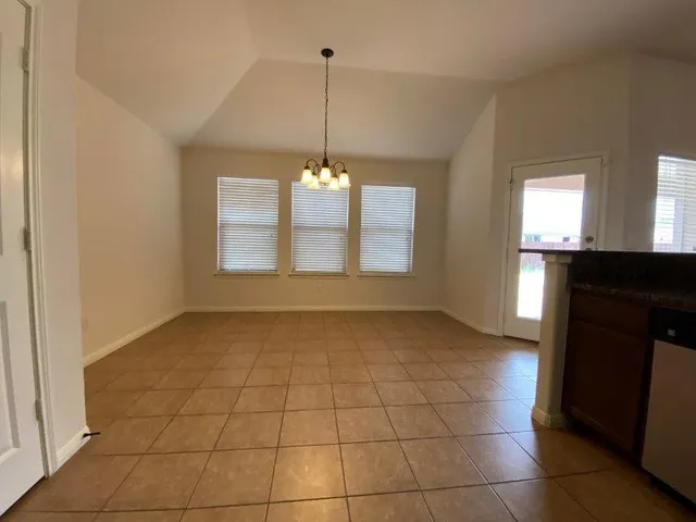 a view of a kitchen with a sink and a window