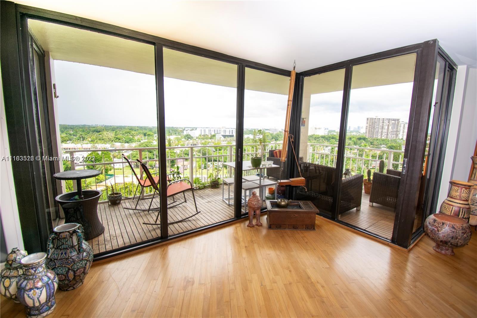 1000 Quayside Terrace, Unit 1205 Miami, FL 33138 - Photo 12 of 12 a living room with furniture and floor to ceiling windows