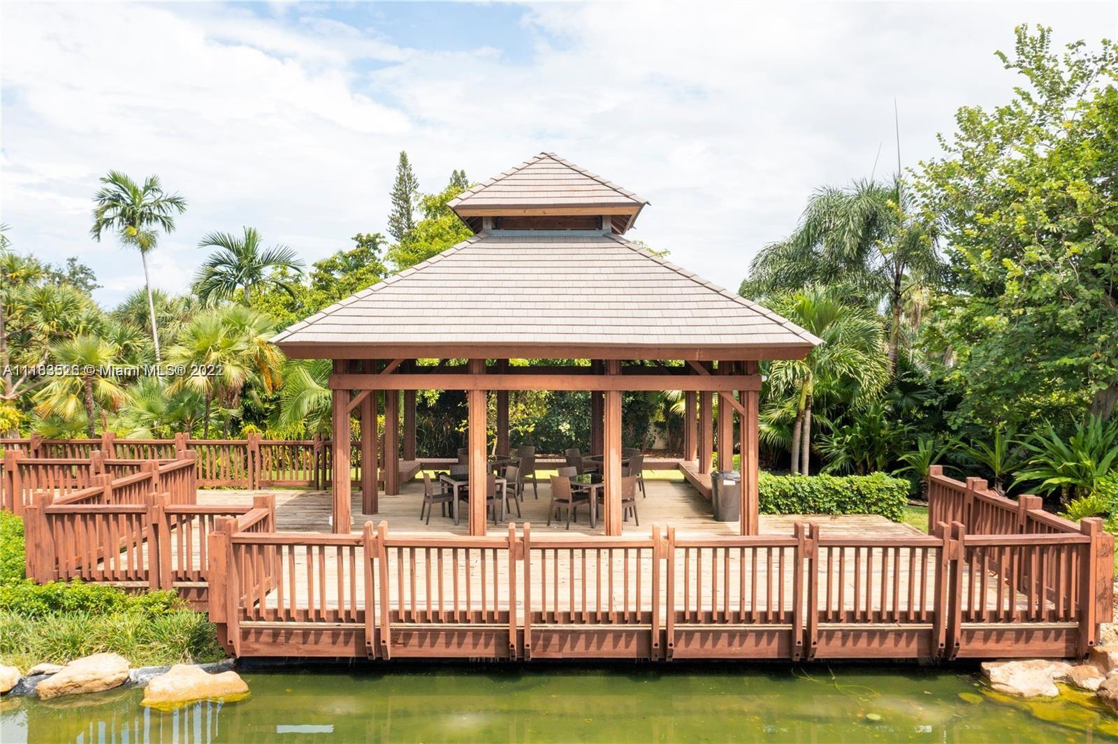 1000 Quayside Terrace, Unit 1205 Miami, FL 33138 - Photo 3 of 12 a view of a house with a wooden deck and a yard