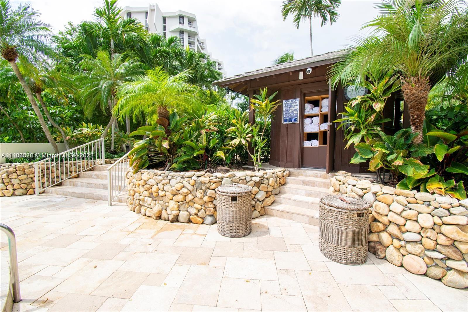 1000 Quayside Terrace, Unit 1205 Miami, FL 33138 - Photo 7 of 12 a view of a patio with table and chairs and potted plants