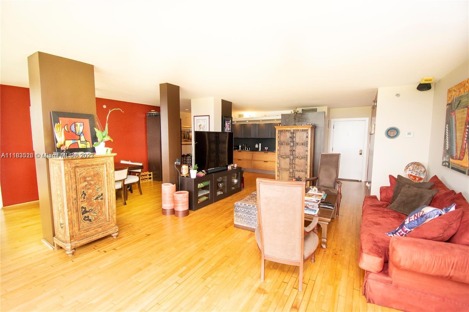 1000 Quayside Terrace, Unit 1205 Miami, FL 33138 - Photo 10 of 12 a living room with furniture and a flat screen tv