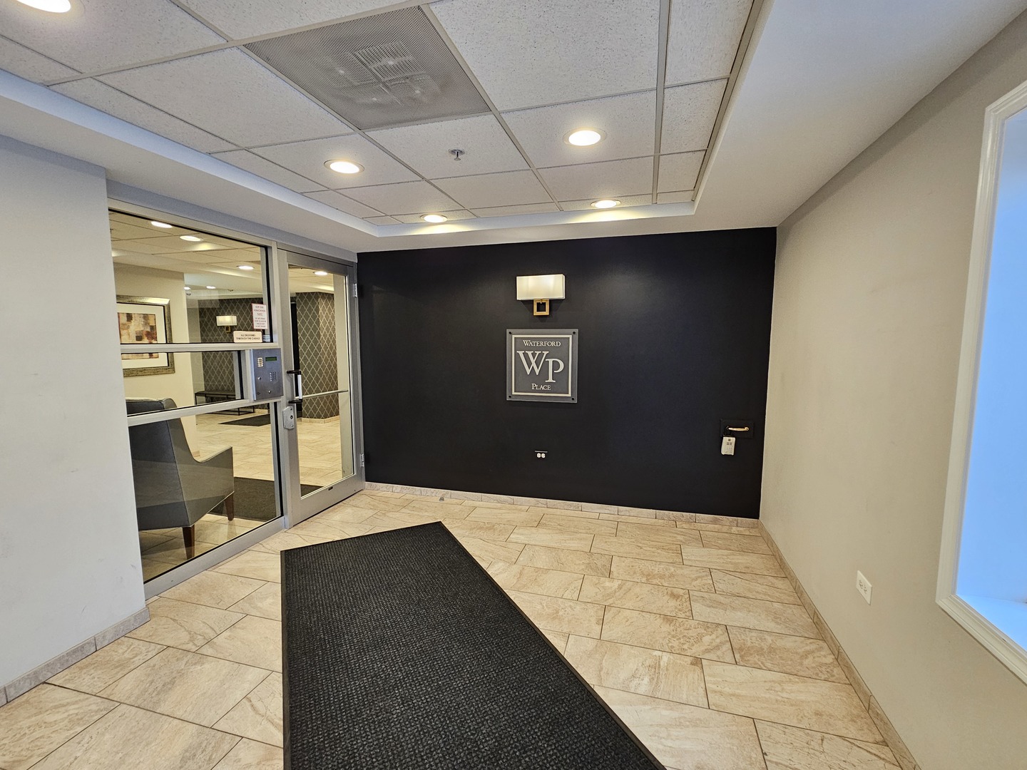 405 West Front Street, Unit 3207 Wheaton, IL 60187 - Photo 2 of 16 a view of hallway with a couch