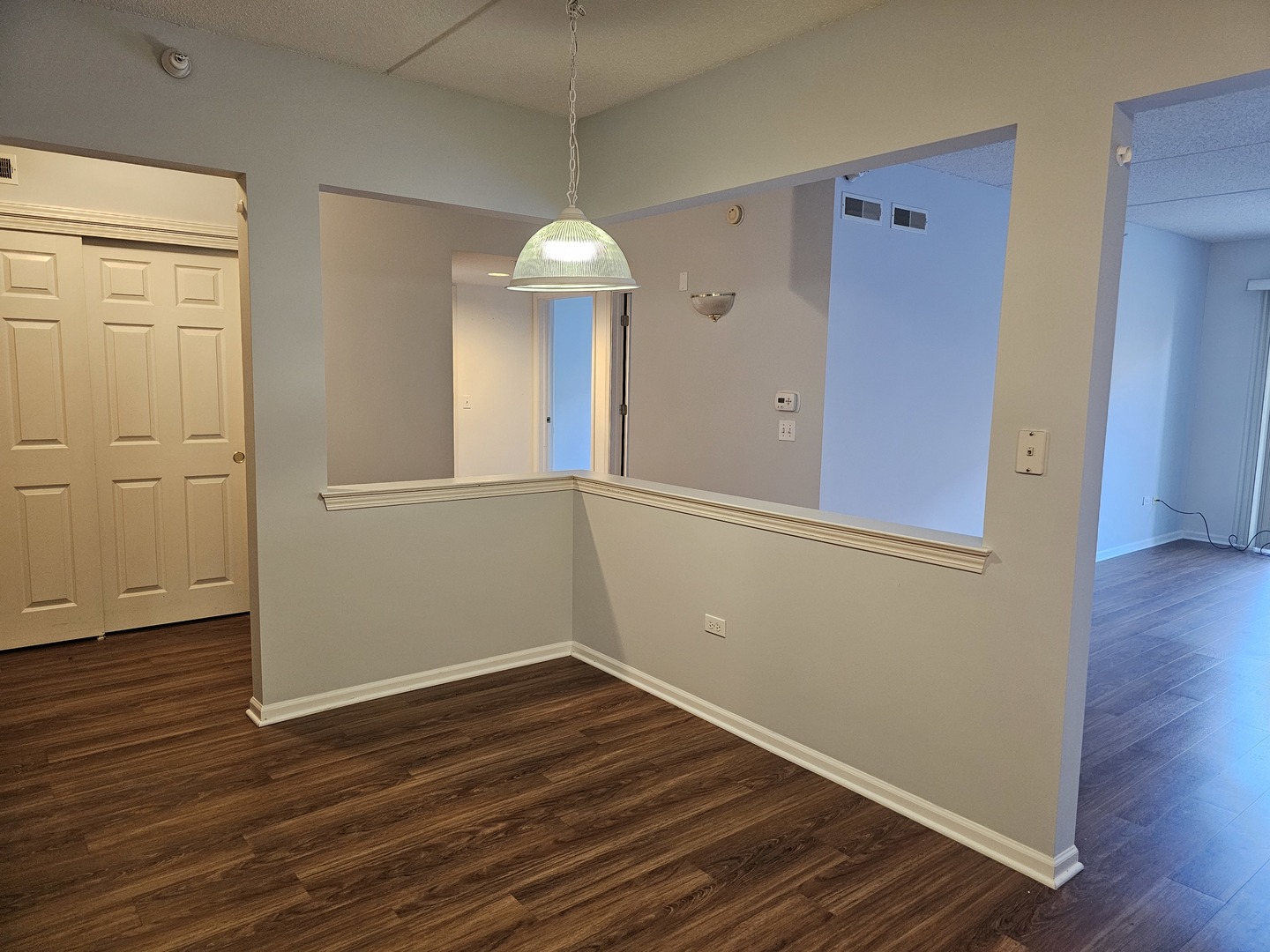 405 West Front Street, Unit 3207 Wheaton, IL 60187 - Photo 4 of 16 an empty room with wooden floor and windows