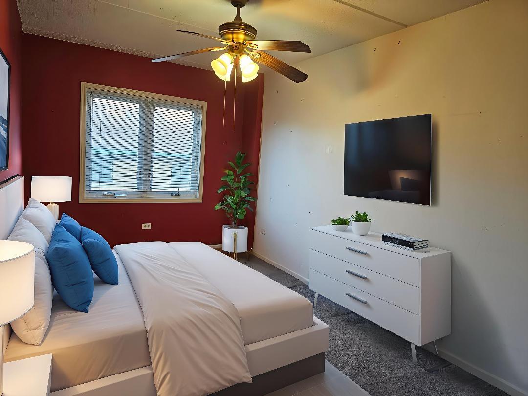 405 West Front Street, Unit 3207 Wheaton, IL 60187 - Photo 8 of 16 a bedroom with a bed and a flat screen tv