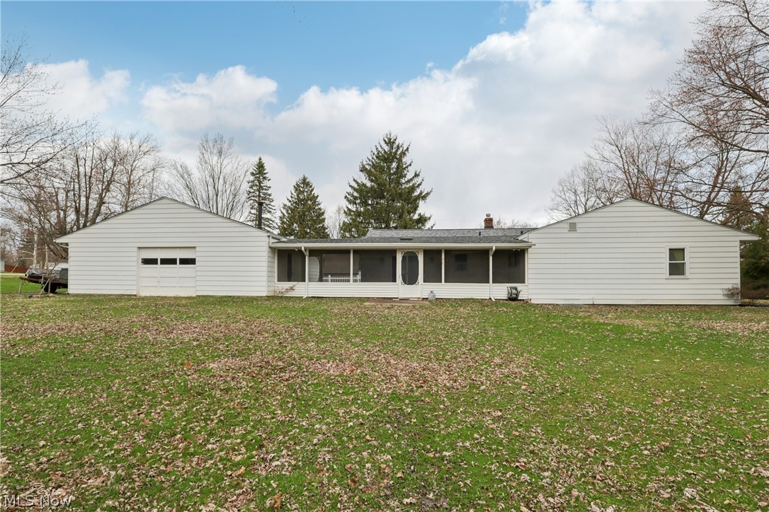 402 Yager Road Clinton, OH 44216 - Photo 36 of 38 Back of property with a sun room / 3 season room, second garage door entrance and large yard