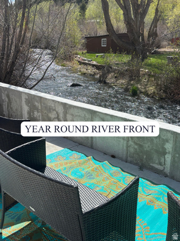 2189 Samak Park Loop, Unit 43 Kamas, UT 84036 - Photo 1 of 48 Riverside patio with concrete retaining wall overlooking a flowing river