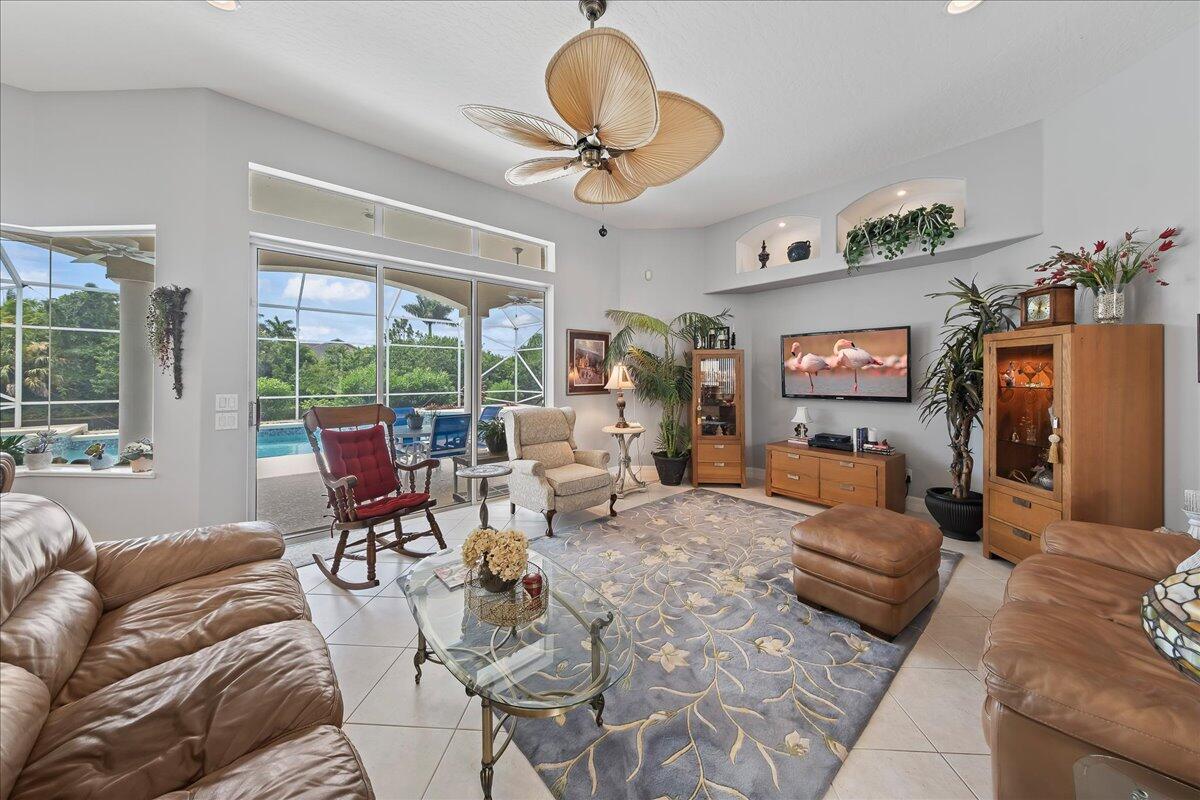 4300 Stoney Point Road Melbourne, FL 32940 - Photo 11 of 37 a living room with furniture and a floor to ceiling window