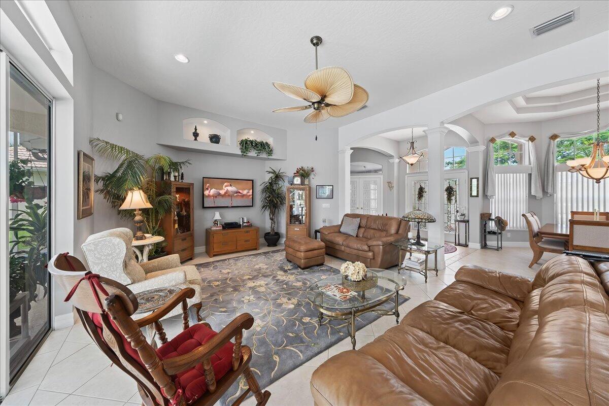 4300 Stoney Point Road Melbourne, FL 32940 - Photo 12 of 37 a living room with furniture a chandelier and a large mirror