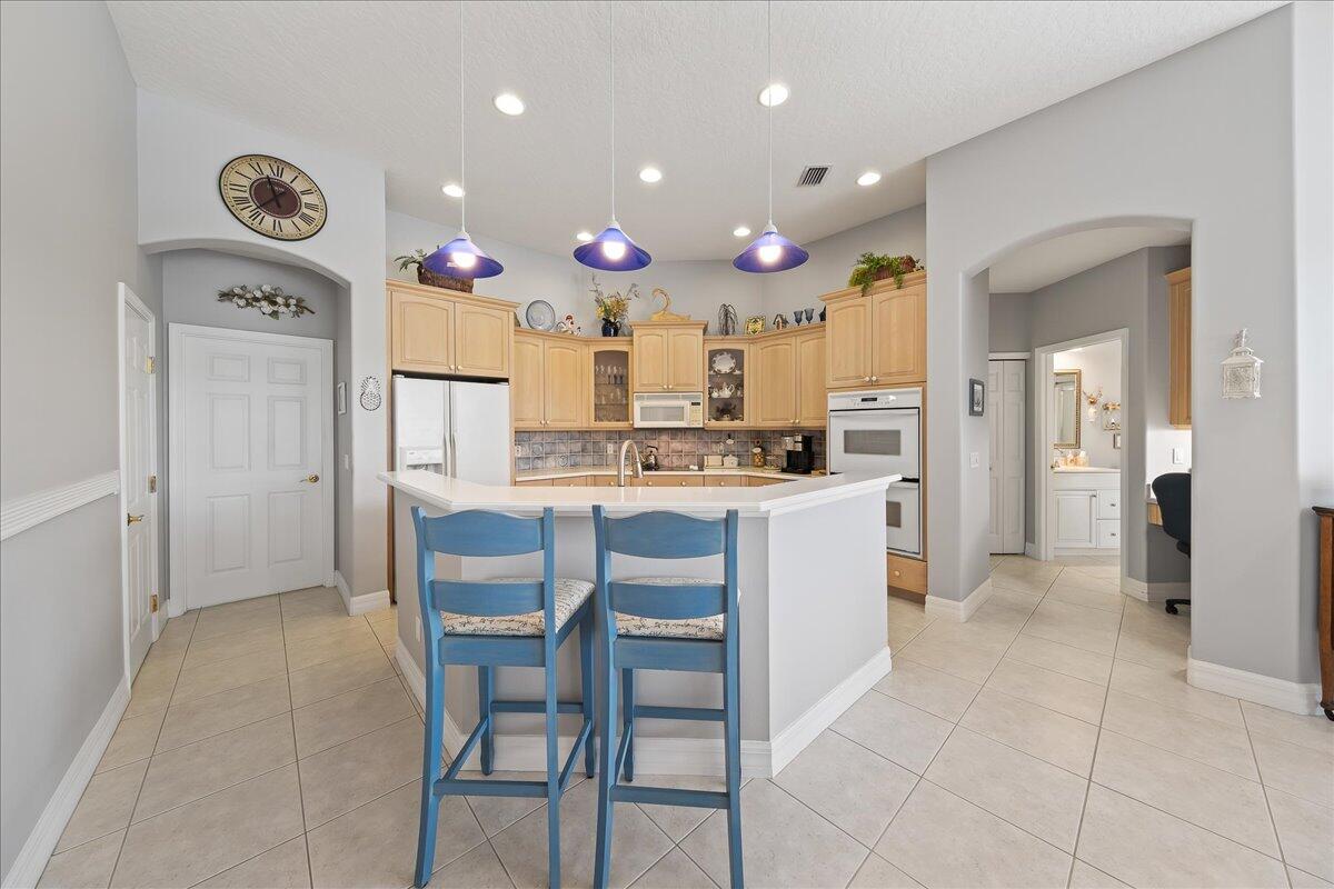 4300 Stoney Point Road Melbourne, FL 32940 - Photo 13 of 37 a kitchen with a refrigerator and cabinets
