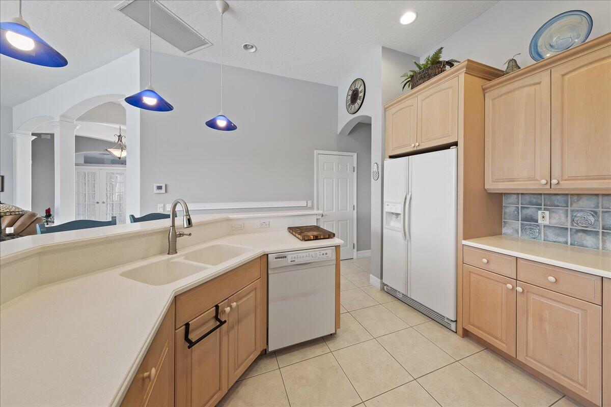 4300 Stoney Point Road Melbourne, FL 32940 - Photo 14 of 37 a kitchen with a sink refrigerator and cabinets