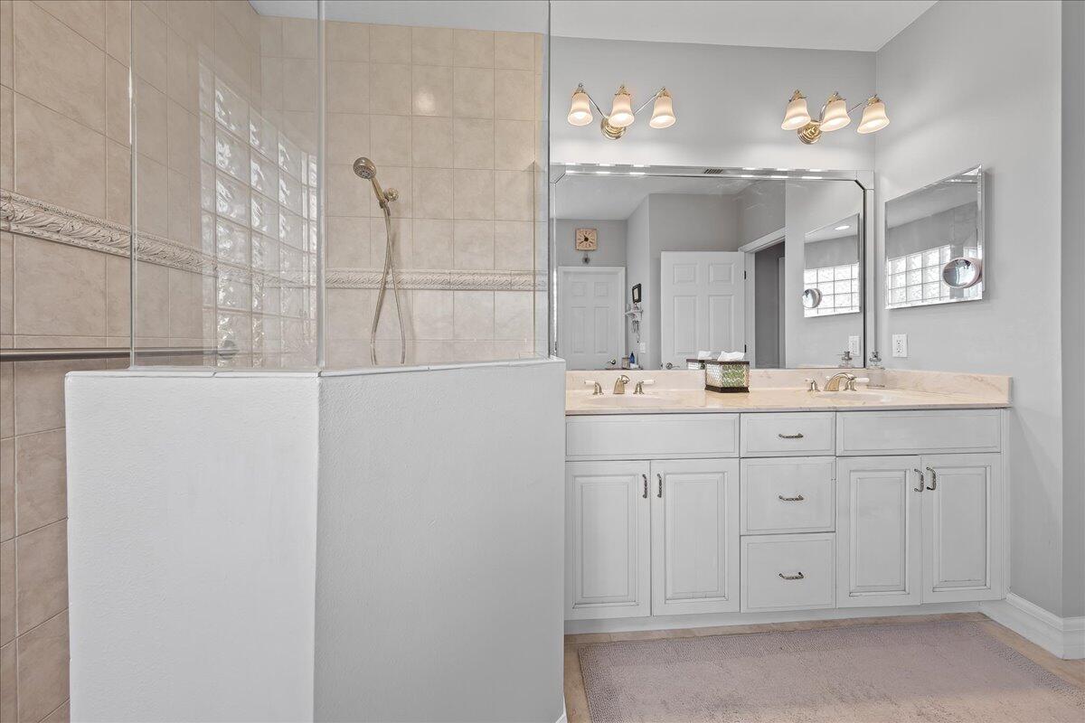 4300 Stoney Point Road Melbourne, FL 32940 - Photo 21 of 37 a bathroom with a sink vanity and a mirror