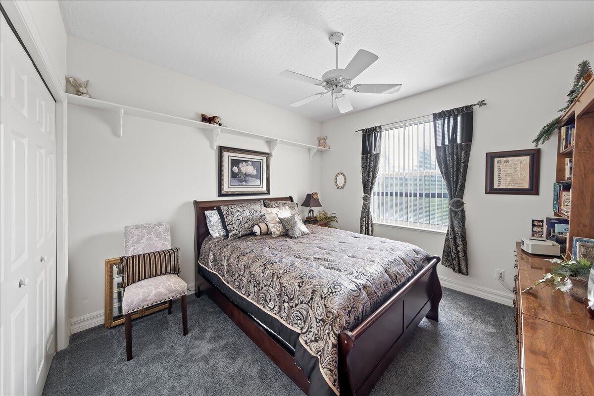 4300 Stoney Point Road Melbourne, FL 32940 - Photo 22 of 37 a bedroom with a bed and a chandelier