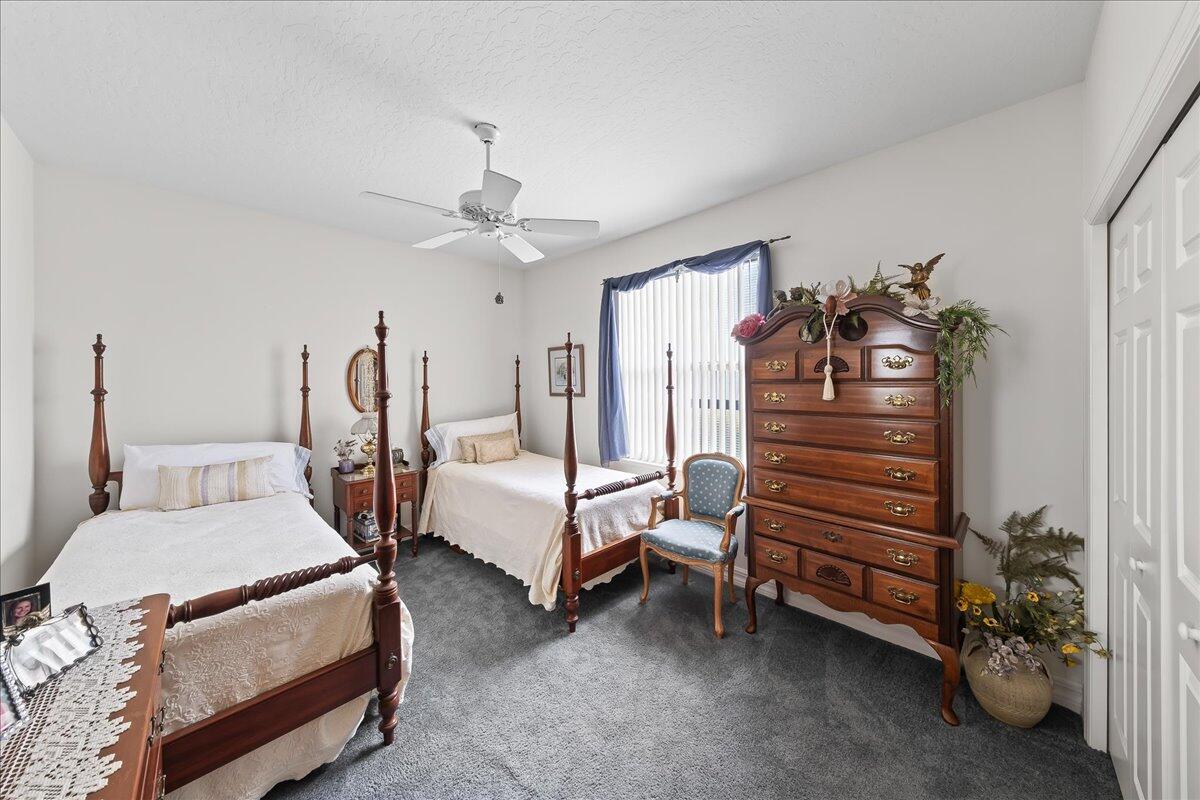 4300 Stoney Point Road Melbourne, FL 32940 - Photo 23 of 37 a bedroom with bed and a chandelier