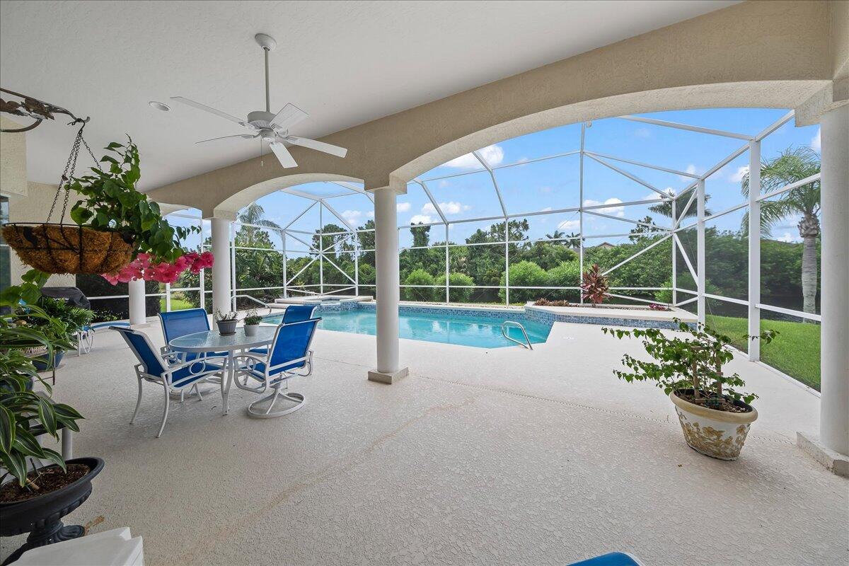 4300 Stoney Point Road Melbourne, FL 32940 - Photo 3 of 37 a view of a patio with table and chairs under an umbrella