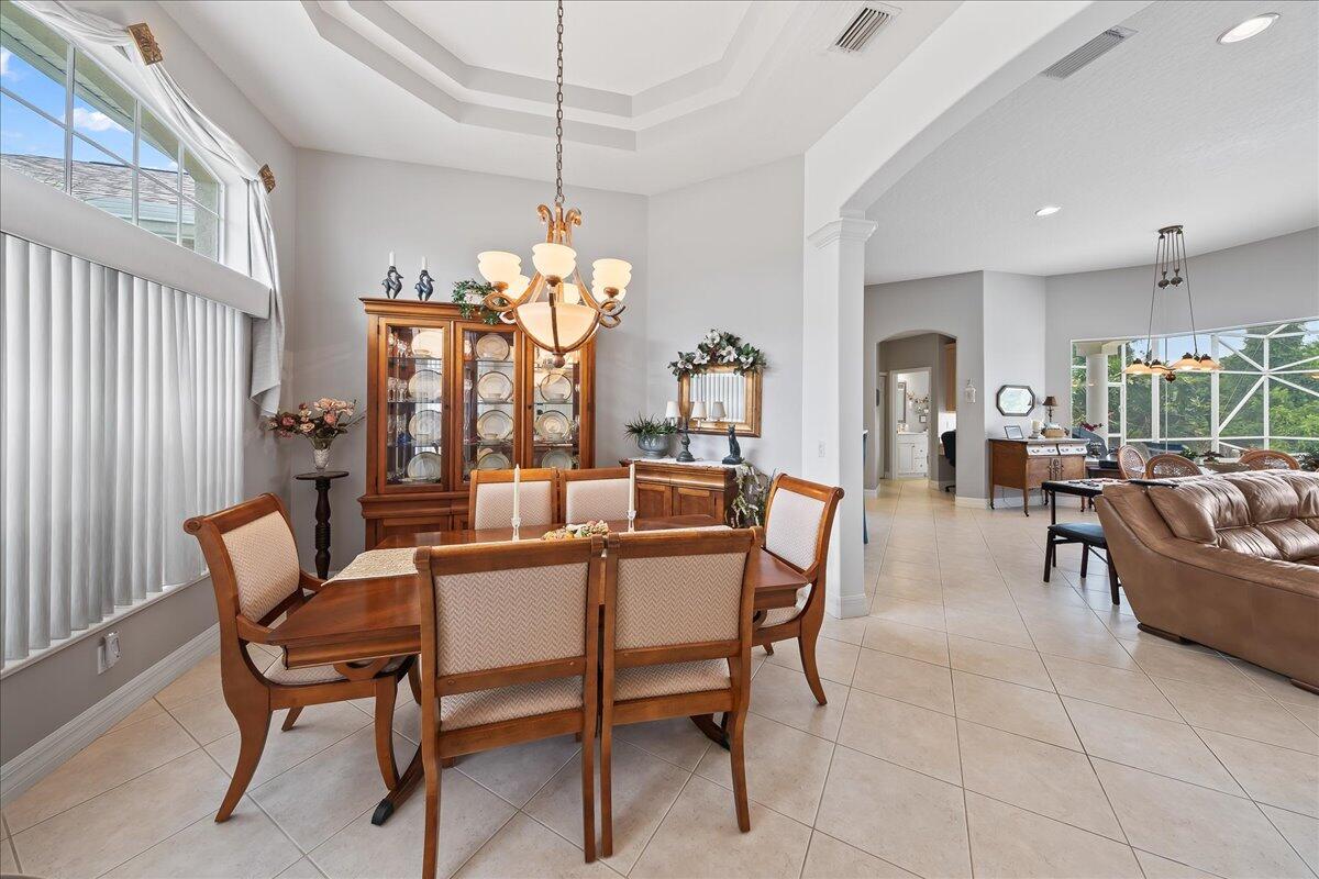 4300 Stoney Point Road Melbourne, FL 32940 - Photo 10 of 37 a dining room with furniture a chandelier and window