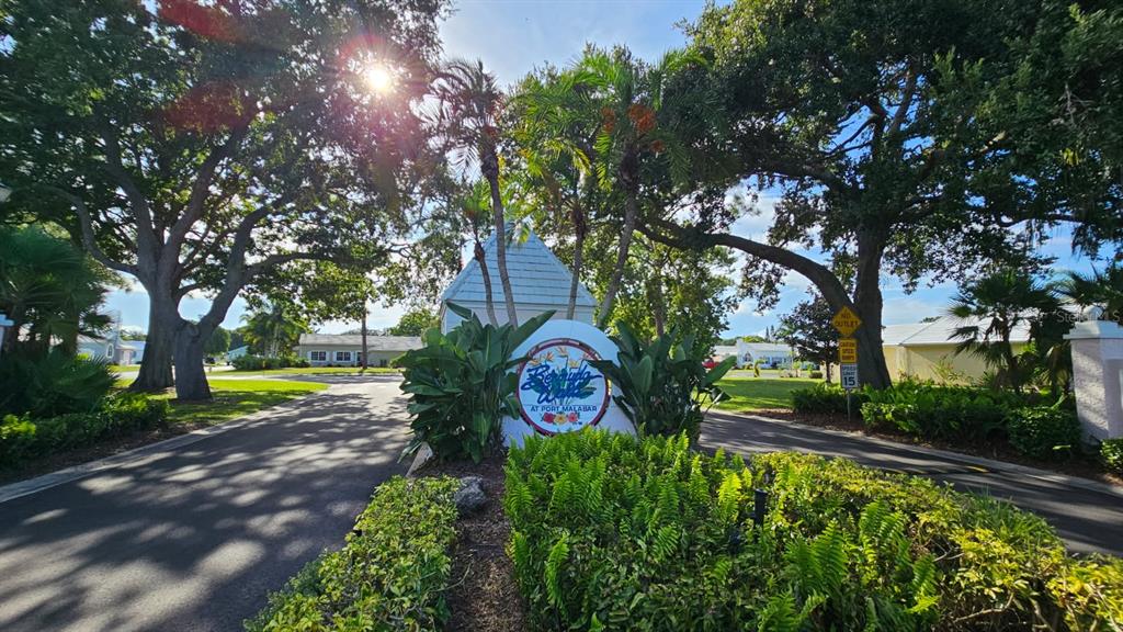 1941 Myrtle Court Northeast Palm Bay, FL 32905 - Photo 2 of 5 a sign that is sitting in the middle of a garden