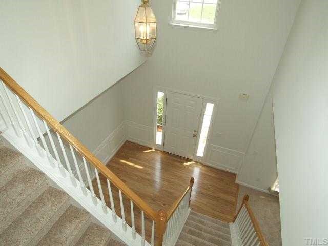 401 Grassy Point Road Apex, NC 27502 - Photo 3 of 12 Dramatic Foyer - Soars to the Second Floor. Beautiful NEW Hardwood Flooring Compliments the Foyer.