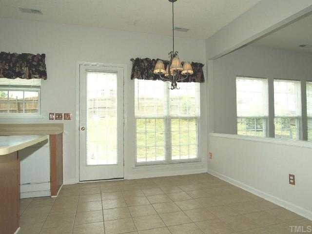 401 Grassy Point Road Apex, NC 27502 - Photo 6 of 12 Breakfast Room Adjacent to the Kitchen and Family Room. New Lighting Fixture - Activity Central w/ View of BackYard.