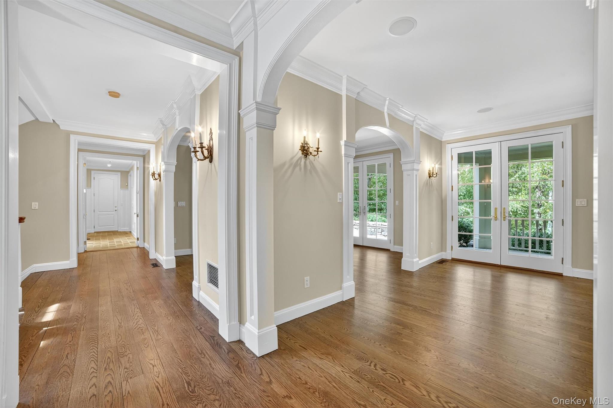6 Todd Road Katonah, NY 10536 - Photo 9 of 50 Corridor with french doors, dark wood-style flooring, crown molding, and arched walkways
