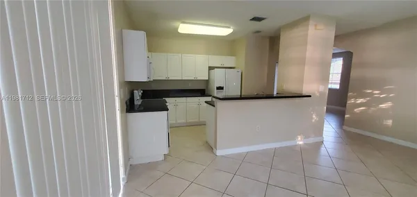 a kitchen with a sink a stove and refrigerator
