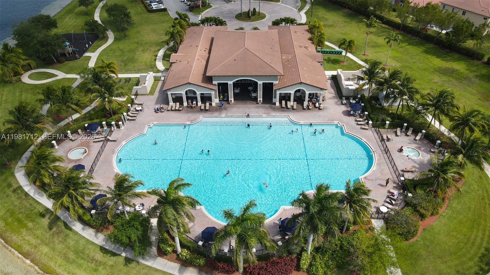 9267 Southwest 227th Street, Unit 2 Miami, FL 33190 - Photo 18 of 24 an aerial view of a house with garden space and lake view