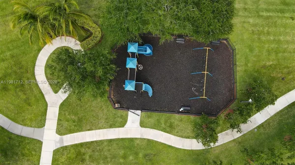 an aerial view of a house with a yard
