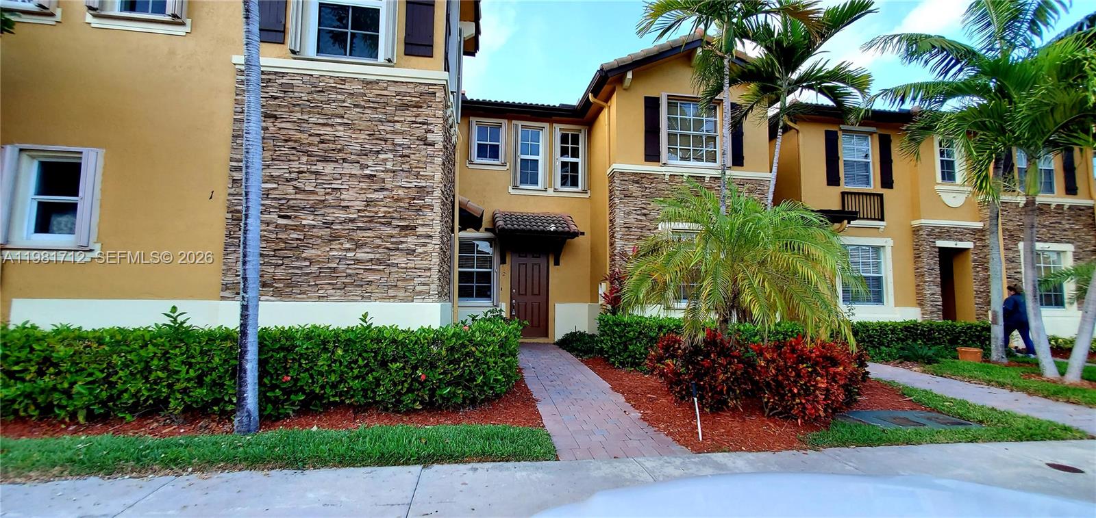 9267 Southwest 227th Street, Unit 2 Miami, FL 33190 - Photo 20 of 24 a front view of a house with a yard