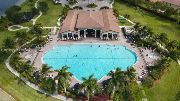 an aerial view of a house with a swimming pool yard and outdoor seating