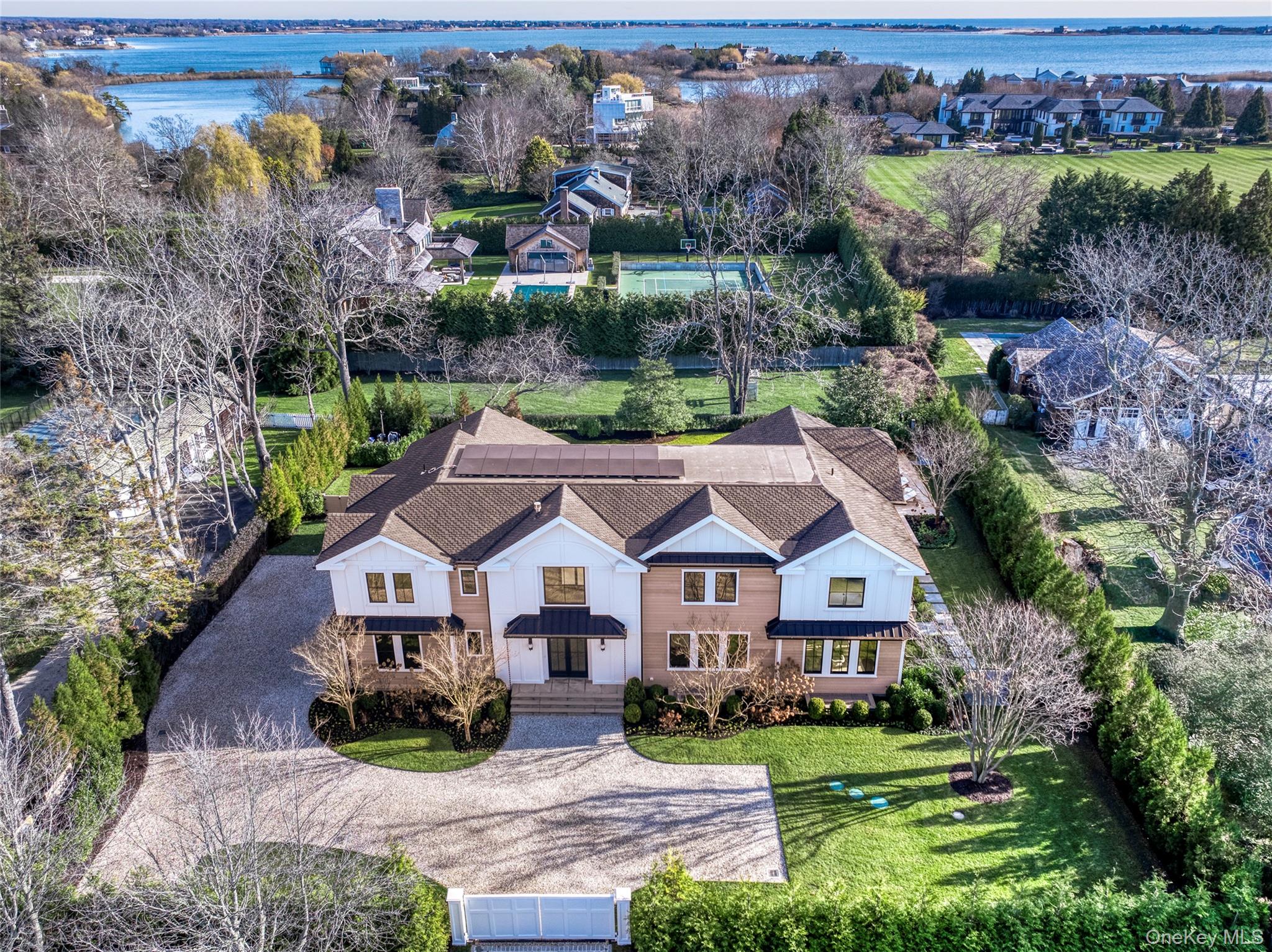 Aerial perspective of suburban area featuring a large body of water