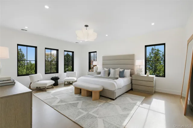 a large bedroom with a large bed and windows