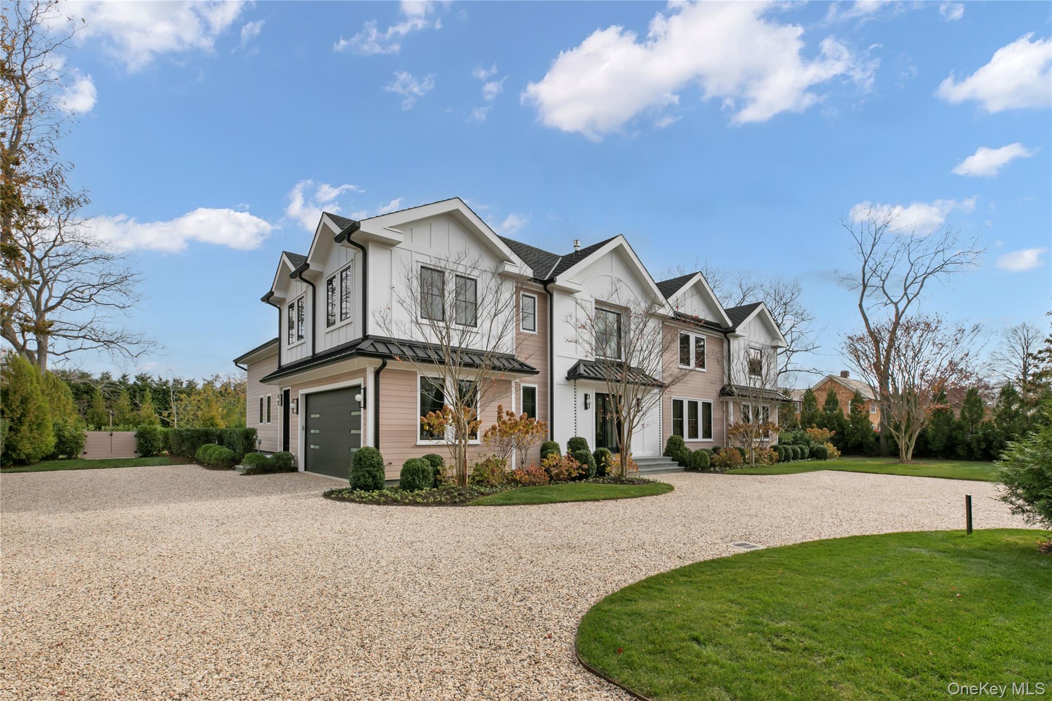 158 Cobb Road Water Mill, NY 11976 - Photo 2 of 43 Modern farmhouse with curved driveway, a garage, board and batten siding, and a front lawn
