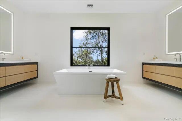 a bathroom with a bathtub and a window