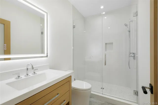 a bathroom with a sink toilet and shower