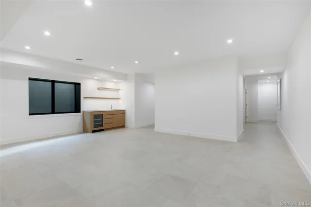 a view of an empty room with a kitchen