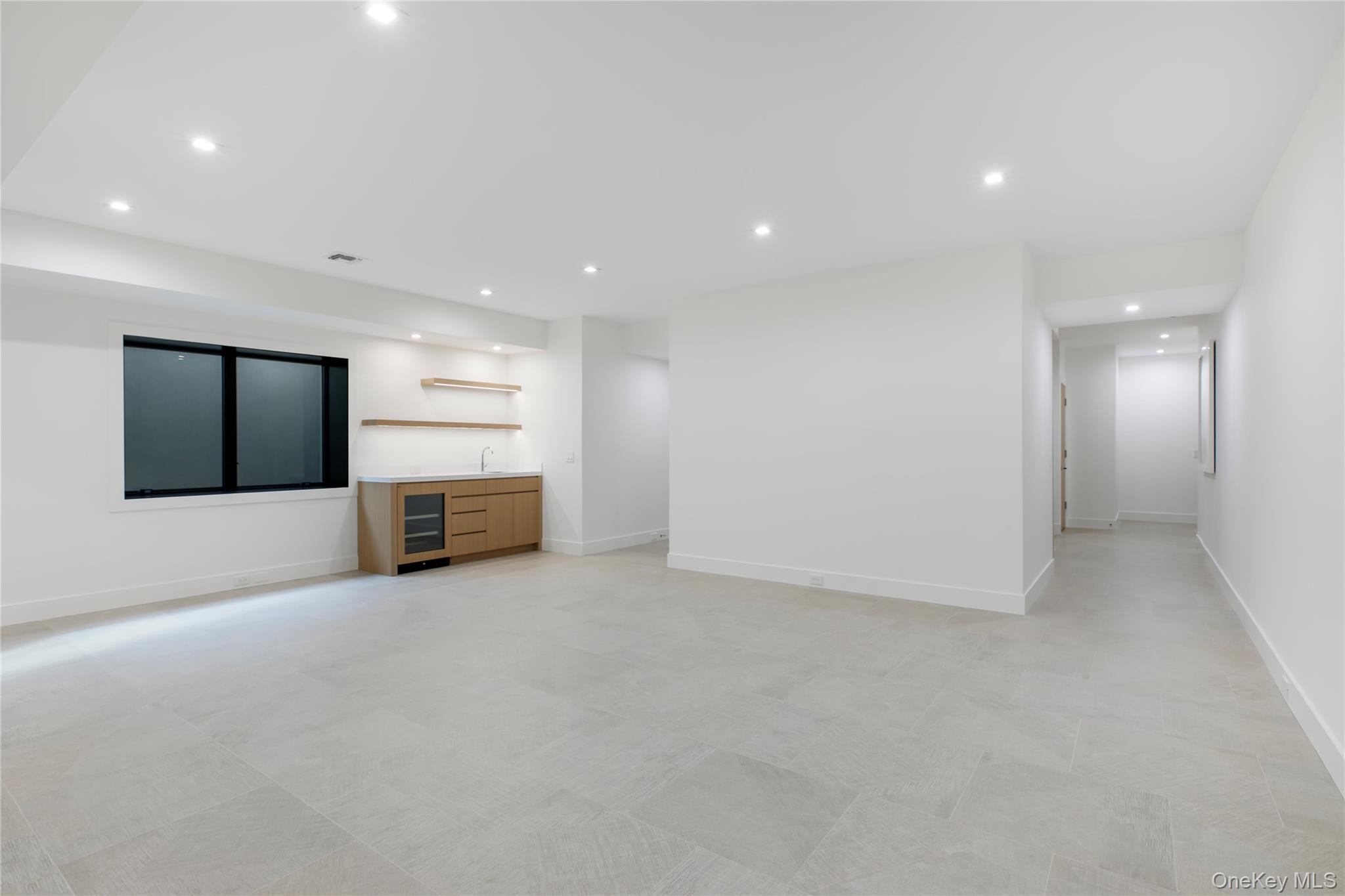 158 Cobb Road Water Mill, NY 11976 - Photo 34 of 43 Unfurnished living room featuring recessed lighting, wet bar, and beverage cooler