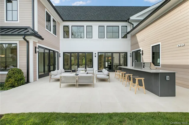 a view of a house with backyard and sitting area