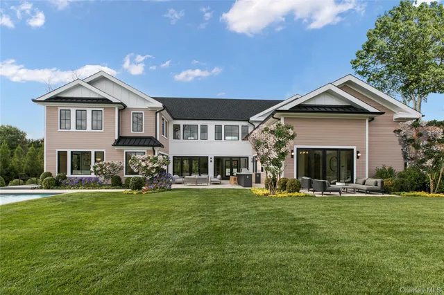 a front view of a house with a yard and trees